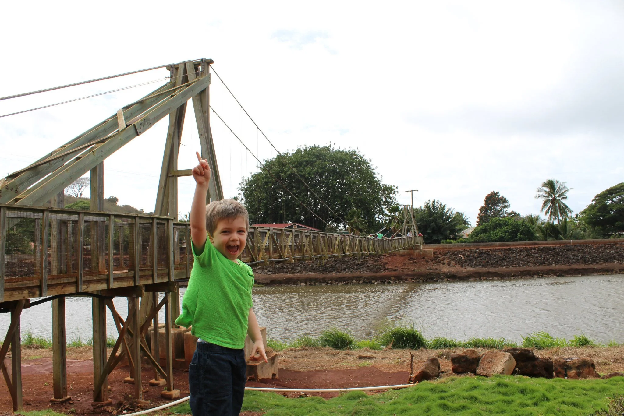 Wells pointing to the swinging bridge. 